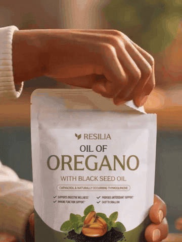 A Resilia Oil of Oregano pouch being opened and two golden softgels poured into her hand