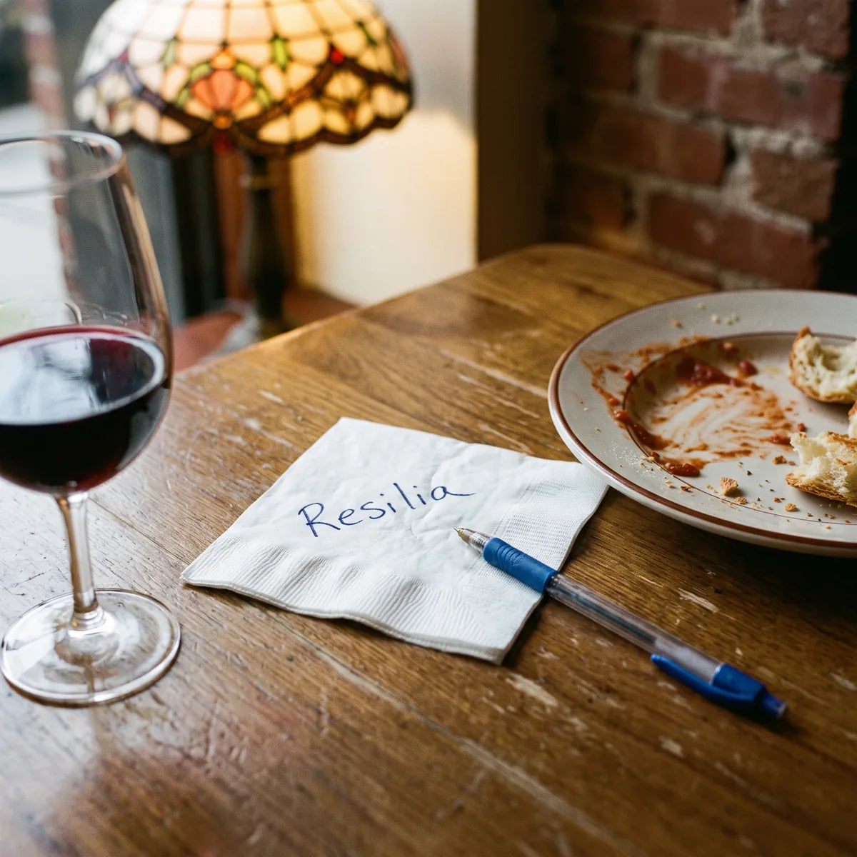 A cocktail napkin with Resilia written on it